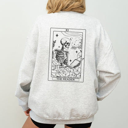 “The Reader Tarot” sweatshirt with mystical tarot card illustration printed on the back, perfect for book lovers and cozy fall vibes.