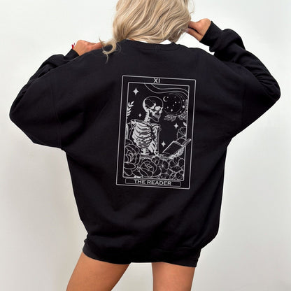 “The Reader Tarot” sweatshirt with mystical tarot card illustration printed on the back, perfect for book lovers and cozy fall vibes.