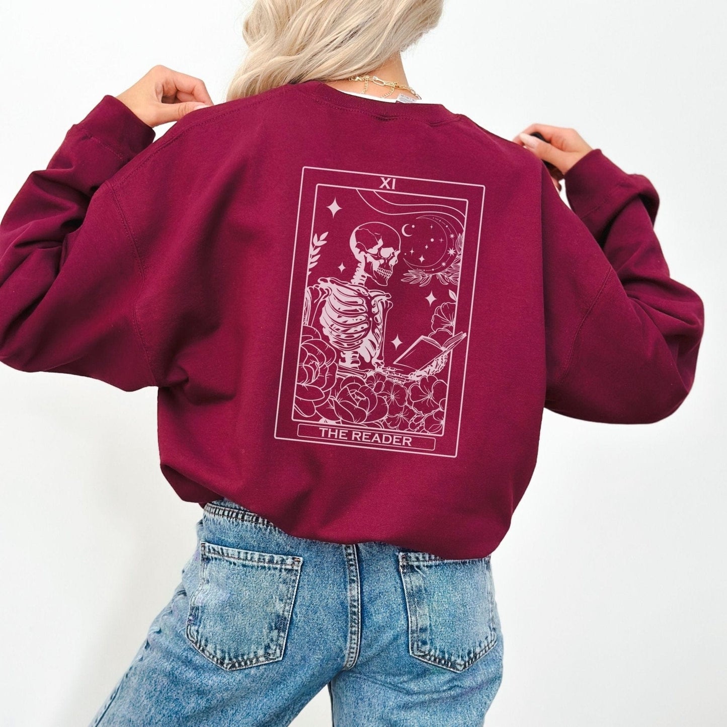 “The Reader Tarot” sweatshirt with mystical tarot card illustration printed on the back, perfect for book lovers and cozy fall vibes.