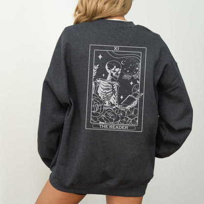 “The Reader Tarot” sweatshirt with mystical tarot card illustration printed on the back, perfect for book lovers and cozy fall vibes.