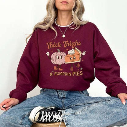 Thanksgiving sweatshirt with "Thick Thighs & Pumpkin Pies" graphic featuring pumpkin and pie characters.