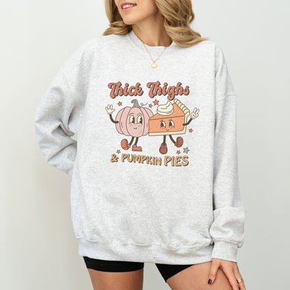 Thanksgiving sweatshirt with "Thick Thighs & Pumpkin Pies" graphic featuring pumpkin and pie characters.