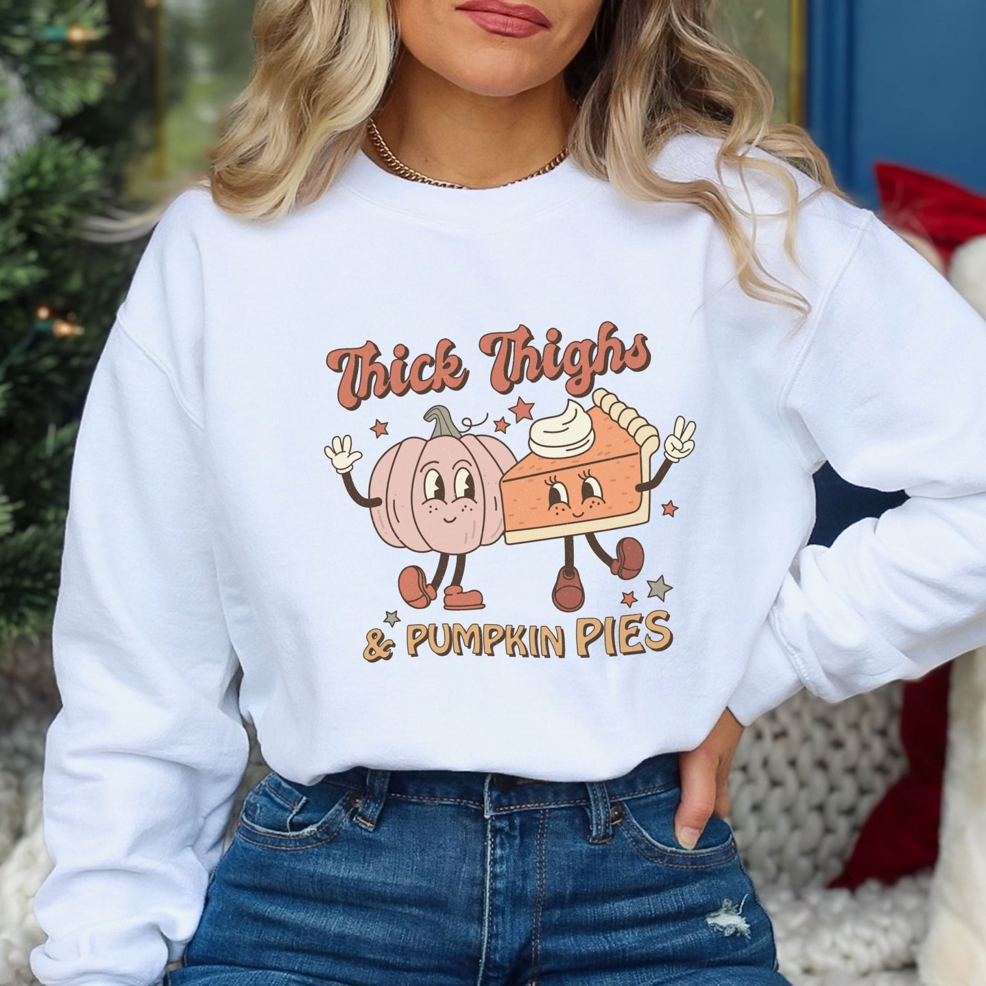 Thanksgiving sweatshirt with "Thick Thighs & Pumpkin Pies" graphic featuring pumpkin and pie characters.