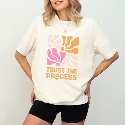 Trust the Process t-shirt with a vibrant floral abstract design in bold colors, perfect for motivation and style.