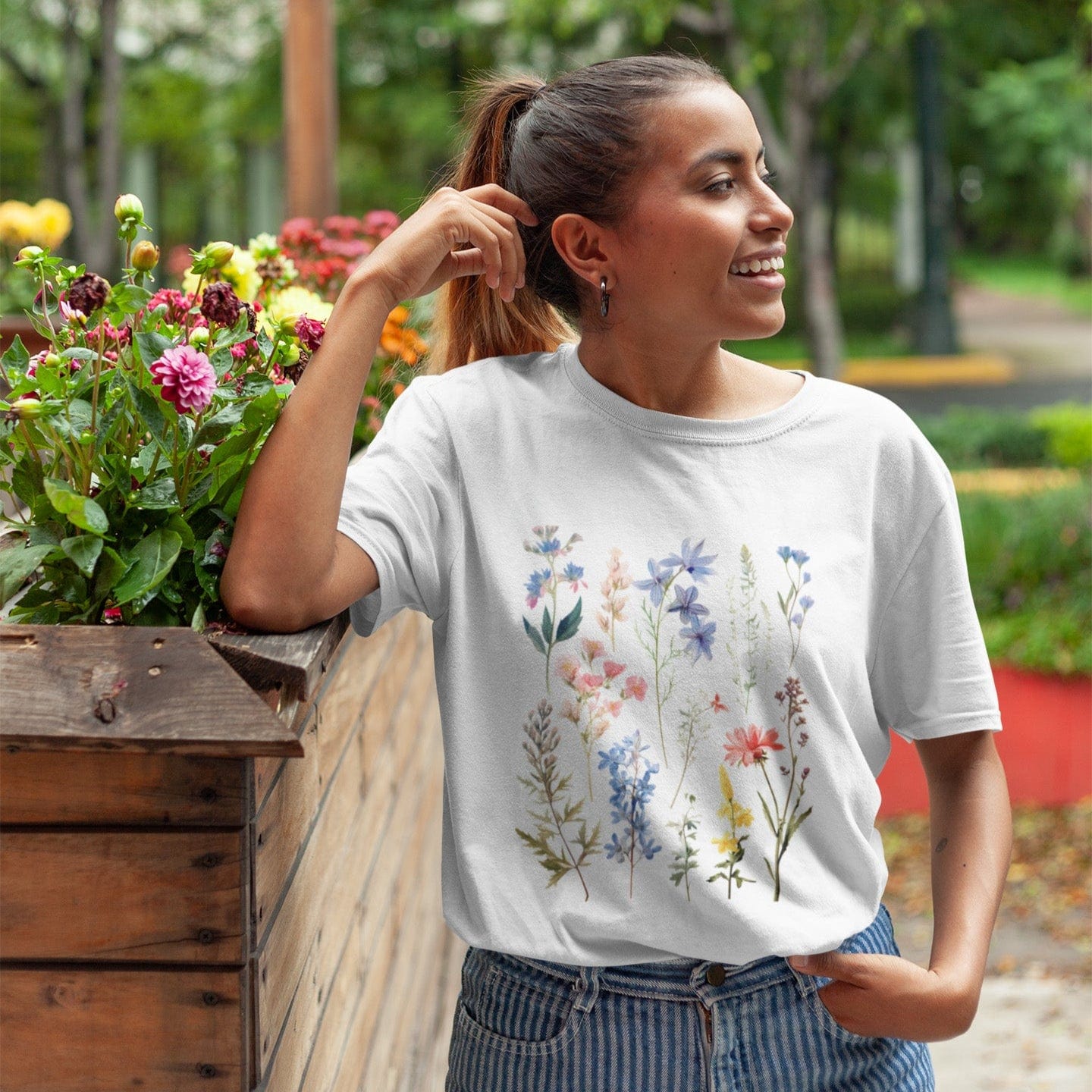 Vintage wildflower t-shirt featuring hand-drawn pastel florals in soft pinks, blues, and yellows arranged in a scattered botanical layout.