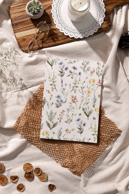 Vintage botanical notebook with watercolor flower pattern, perfect for notes and sketches.