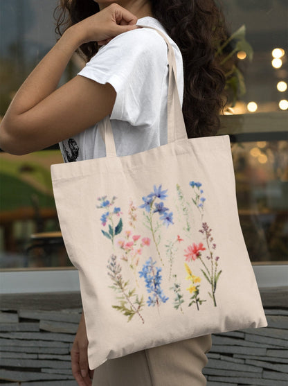 Wildflower boho tote bag with floral design, available in natural and black.