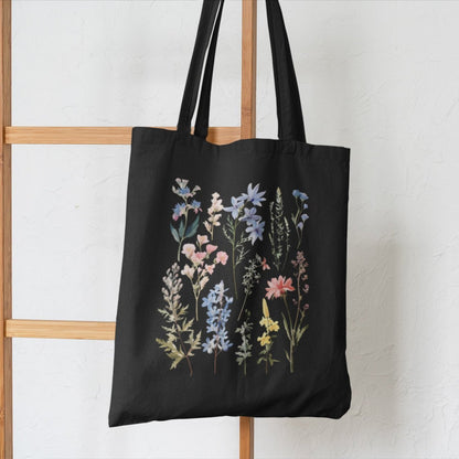 Wildflower boho tote bag with floral design, available in natural and black.