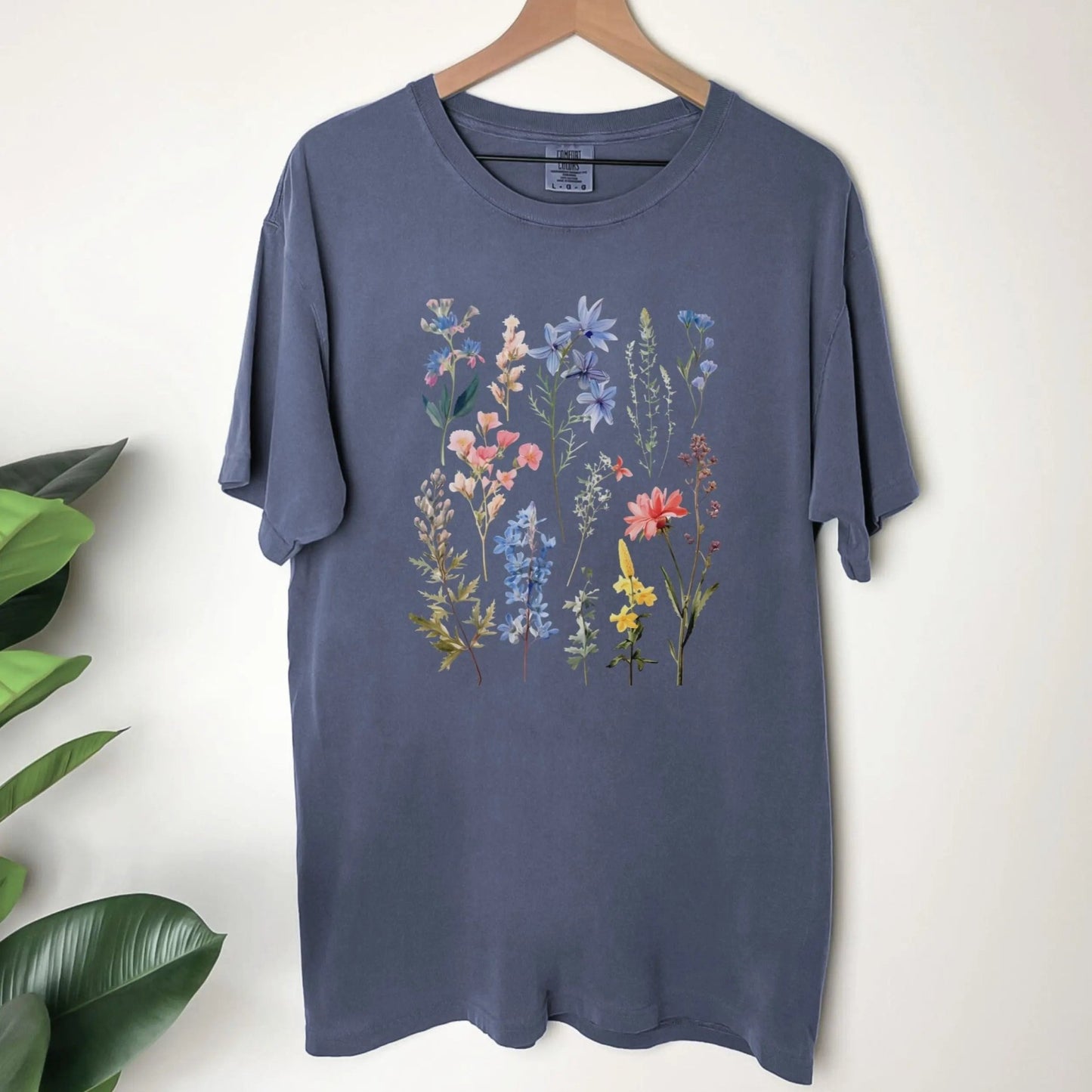 "Vintage Wildflower" shirt with botanical design, 100% cotton, available in 6 colors.