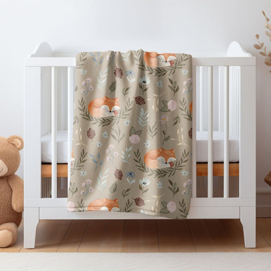 Woodland baby blanket with cute fox design, ideal for nature-themed nurseries.