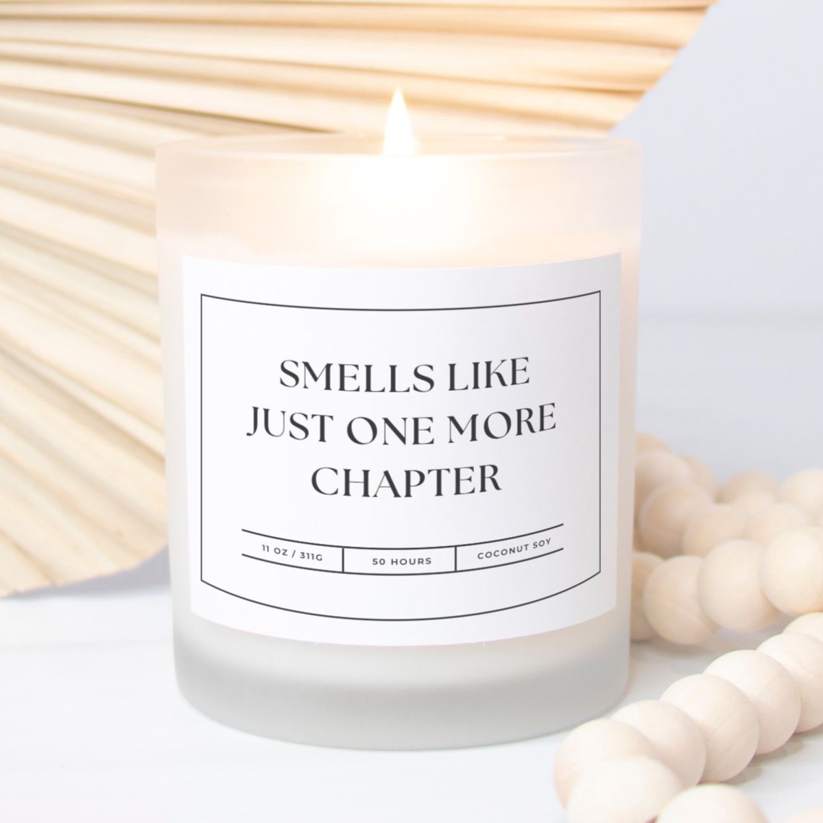 11 oz frosted glass candle with "Smells Like Just One More Chapter" design, perfect for book lovers and cozy nights.