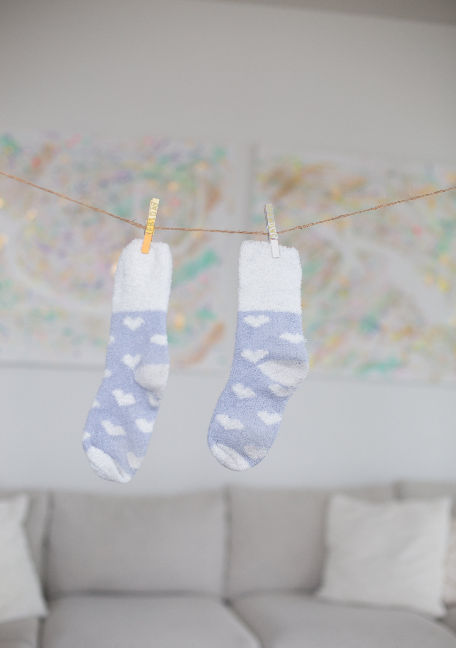 Purple socks hanging on a string